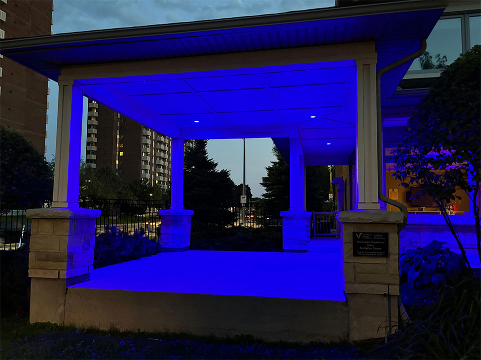 The porch of a house in the evening, a blue light light illuminates the area